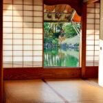 View from a traditional Japanese tatami room looking out over a peaceful garden pond framed by shoji screens.