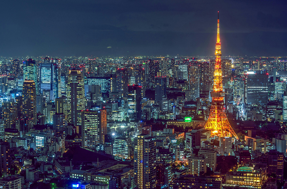 A stunning view of the Tokyo skyline illuminated at night, showcasing vibrant city lights and iconic skyscrapers