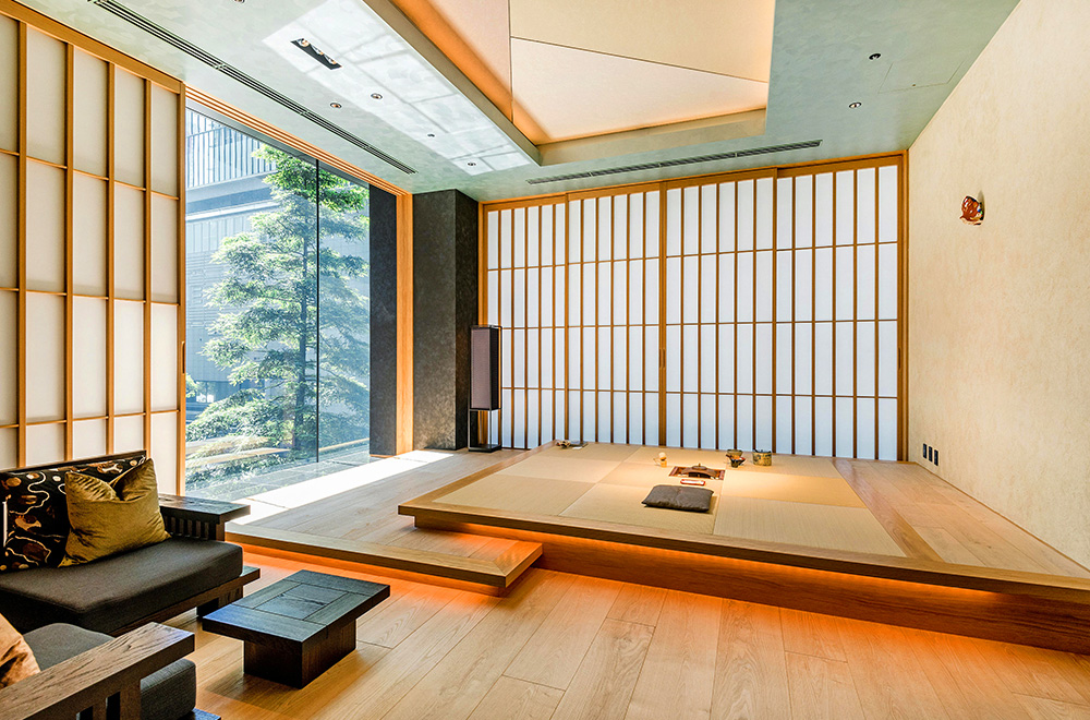 A Japanese modern interior featuring a wooden floor and a stylish couch in a serene room setting