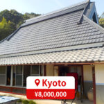 One-story house with a modern roof and large windows, featuring a driveway and parking space, listed for sale in Japan.